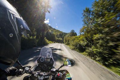 Man driving on a touring motorbike on ruta 7 - the carretera austral