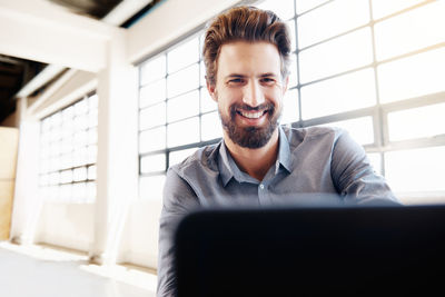 Portrait of smiling businessman in office