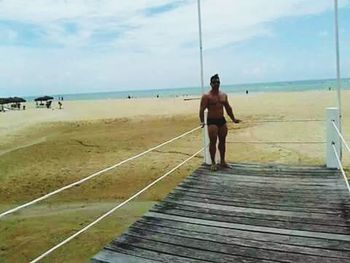 Full length of woman standing on beach