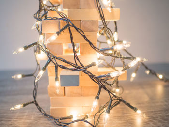 Close-up of illuminated christmas lights against sky