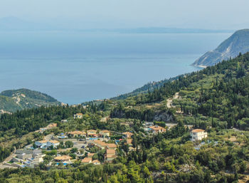 High angle view of townscape by mountain against sky