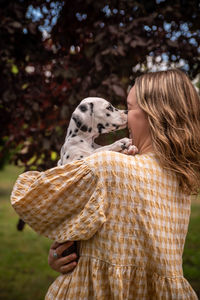 Rear view of woman with dog on field