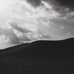 Silhouette of sand dunes in desert