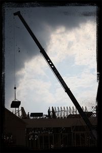 Low angle view of building against cloudy sky