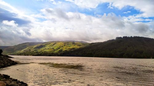 Scenic view of lake and mountains against sky