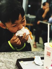 Boy eating food at restaurant