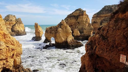 Panoramic view of rocks in sea against sky