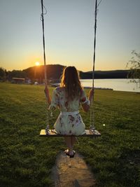 Full length of boy swinging at playground
