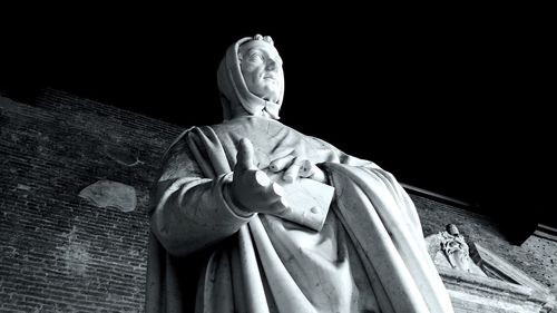 Low angle view of statue at camposanto cemetery at night