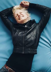 Smiling woman lying on bed at home