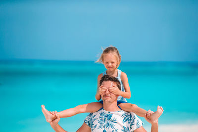 Portrait of smiling woman against sea