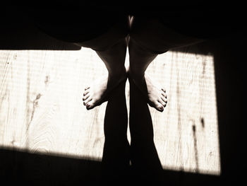 Low section of man standing on tiled floor