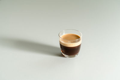 Glass of coffee against white background