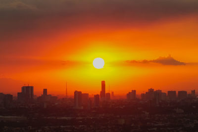 Scenic view of buildings against sky during sunset