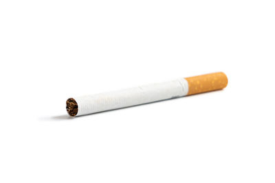 Close-up of cigarette smoking on table