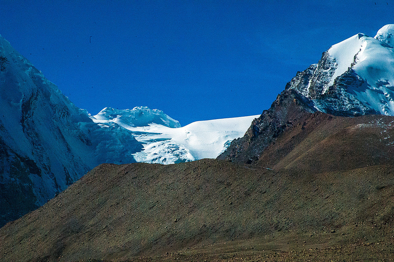 SNOWCAPPED MOUNTAINS AGAINST BLUE SKY