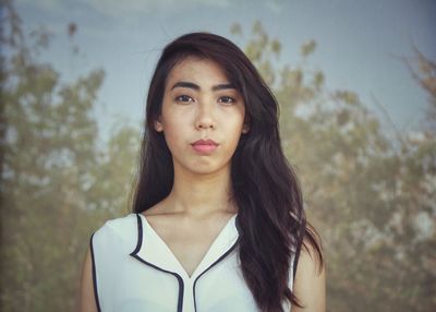 Beautiful young woman against blurred background