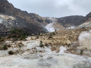 Scenic view of waterfall against sky