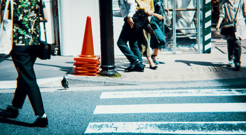 Low section of people walking on road