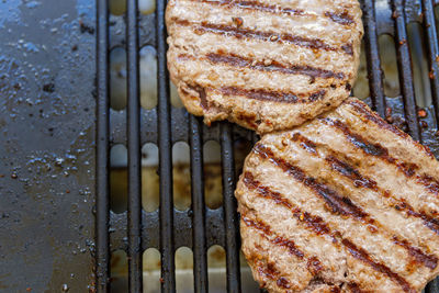 High angle view of meat on barbecue grill