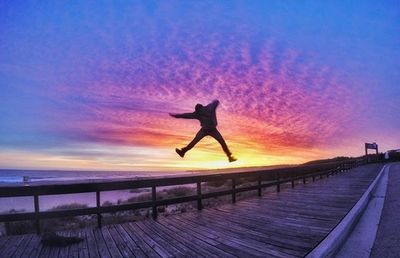 People in sea at sunset