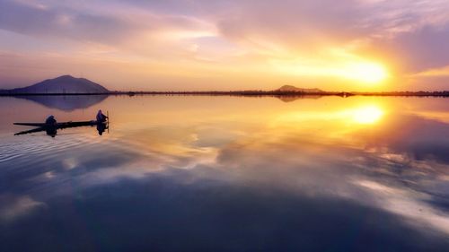 Scenic view of lake against sky during sunset