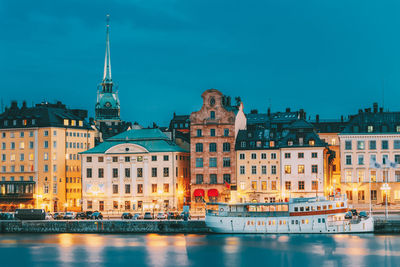 Buildings and harbor against blue sky