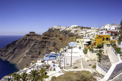 High angle view of buildings against blue sky