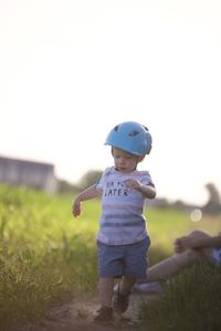 Full length of boy standing on field