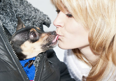 Close-up of dog licking young woman