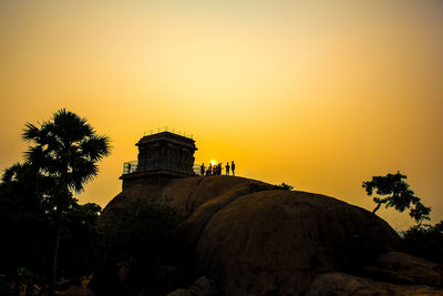 Silhouette of building against sky during sunset