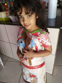 Portrait of smiling girl standing on floor