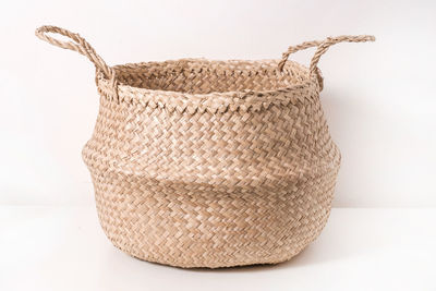 Close-up of wicker basket on white background