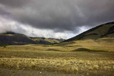 Scenic view of mountains against cloudy sky