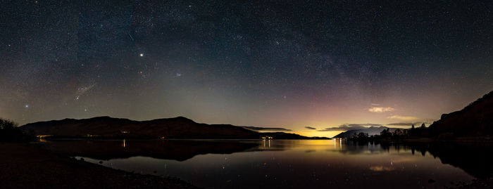 Scenic view of lake against sky at night