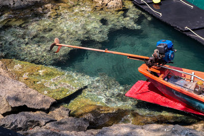High angle view of people on rock by river