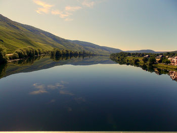 Scenic view of lake and mountains against sky