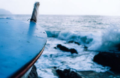 Close-up of sailboat in sea against sky