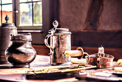 Close-up of old containers on table