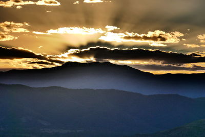 Scenic view of silhouette mountains against sky during sunset