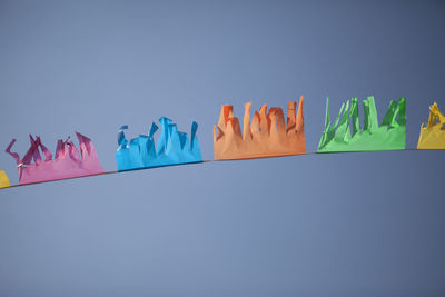 Low angle view of colorful bunting against clear blue sky