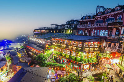 High angle view of illuminated buildings in city at night