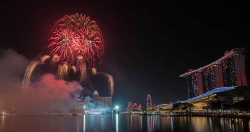 Firework display over river at night