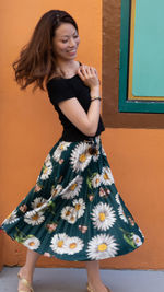 Beautiful young woman standing against wall