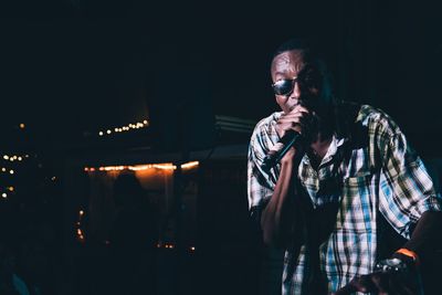 Man photographing illuminated at night