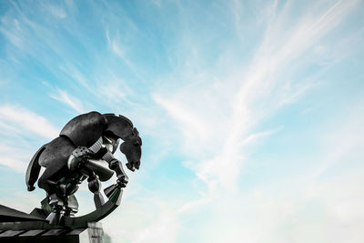 Low angle view of statue against sky