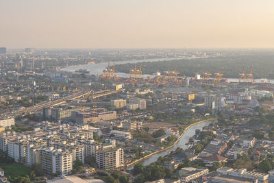 High angle view of illuminated city buildings against sky