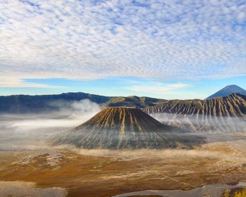 View of volcanic landscape against cloudy sky