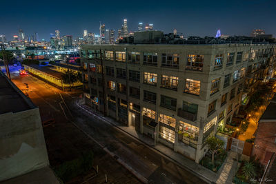 High angle view of illuminated buildings in city at night