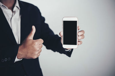 Midsection of man using smart phone